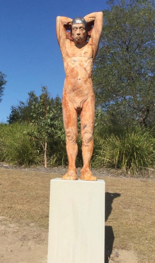 Sculpture in wood of naked swimmer